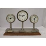 A CLOCKS OF THE WORLD MANTLE CLOCK ON A WOODEN STAND, HEIGHT 24CM, LENGTH 36CM