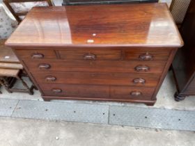 A 19TH CENTURY MAHOGANY CHEST OF THREE SHORT AND THREE LONG GRADUATED DRAWERS WITH CARVED SCOOP