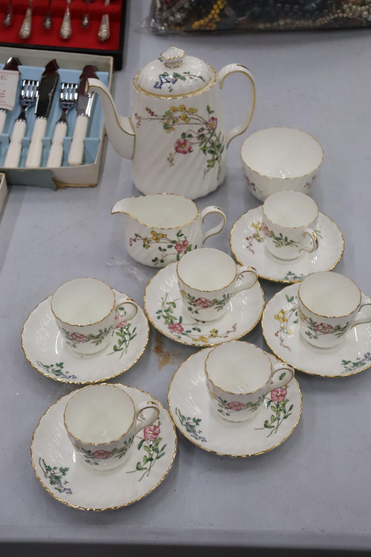 A MINTON 'DAINTY SPRAYS' COFFEE SET TO INCLUDE A COFFEE POT, CREAM JUG, SUGAR BOWL, CUPS AND SAUCERS