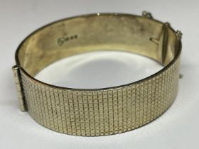 A 22 CARAT GOLD ON SILVER BANGLE