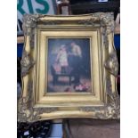 A FRAMED PRINT OF A FATHER AND DAUGHTER IN A GILT FRAME