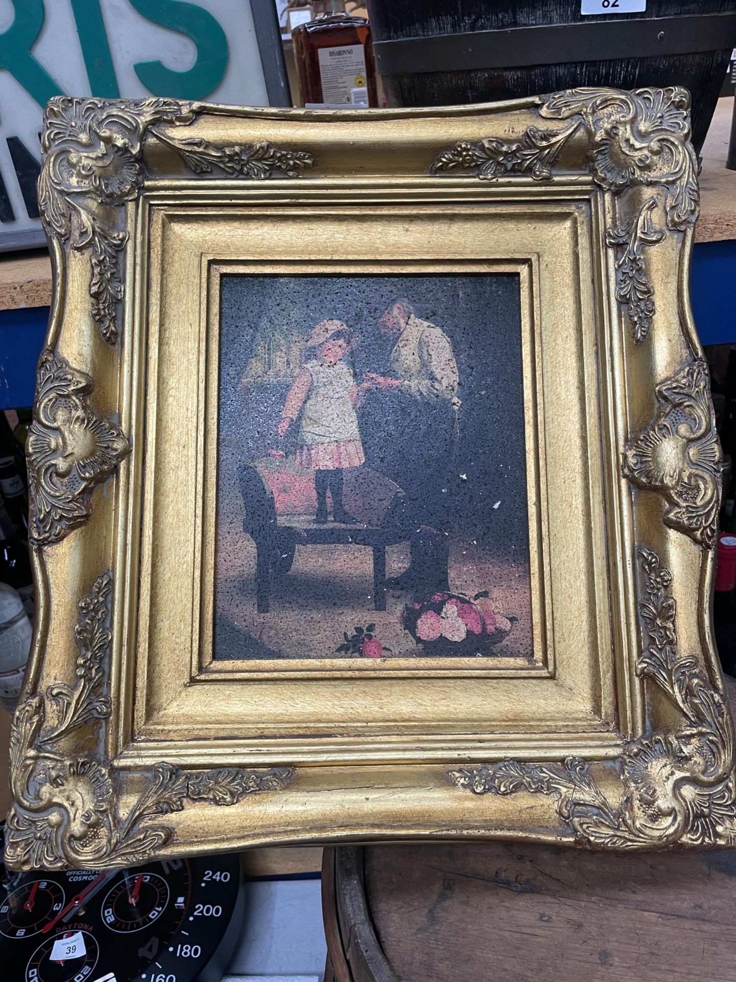 A FRAMED PRINT OF A FATHER AND DAUGHTER IN A GILT FRAME