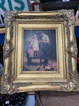 A FRAMED PRINT OF A FATHER AND DAUGHTER IN A GILT FRAME