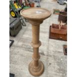 A WOODEN PLANT STAND WITH TWISTED PEDESTAL BASE
