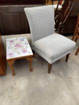 A MODERN BEDROOM CHAIR AND A TILED TOP COFFEE TABLE