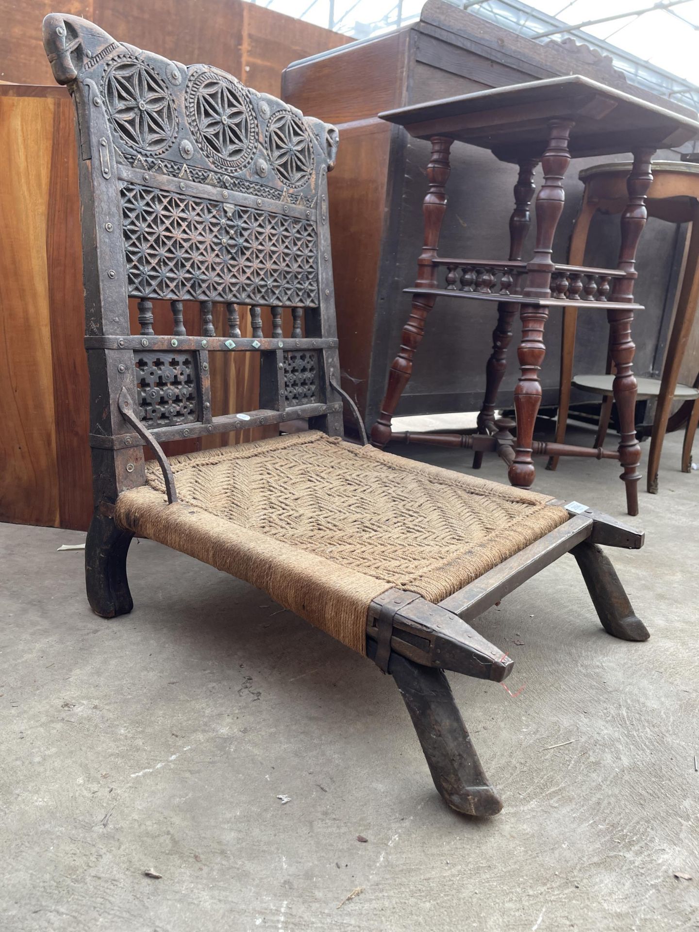 AN INDIAN TRIBAL LOW CHAIR WITH CARVED BACK AND WOVEN SEAT - Image 2 of 6