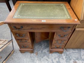 A YEW WOOD DOUBLE PEDESTAL DESK ENCLOSING SEVEN DRAWERS 30" x 20"
