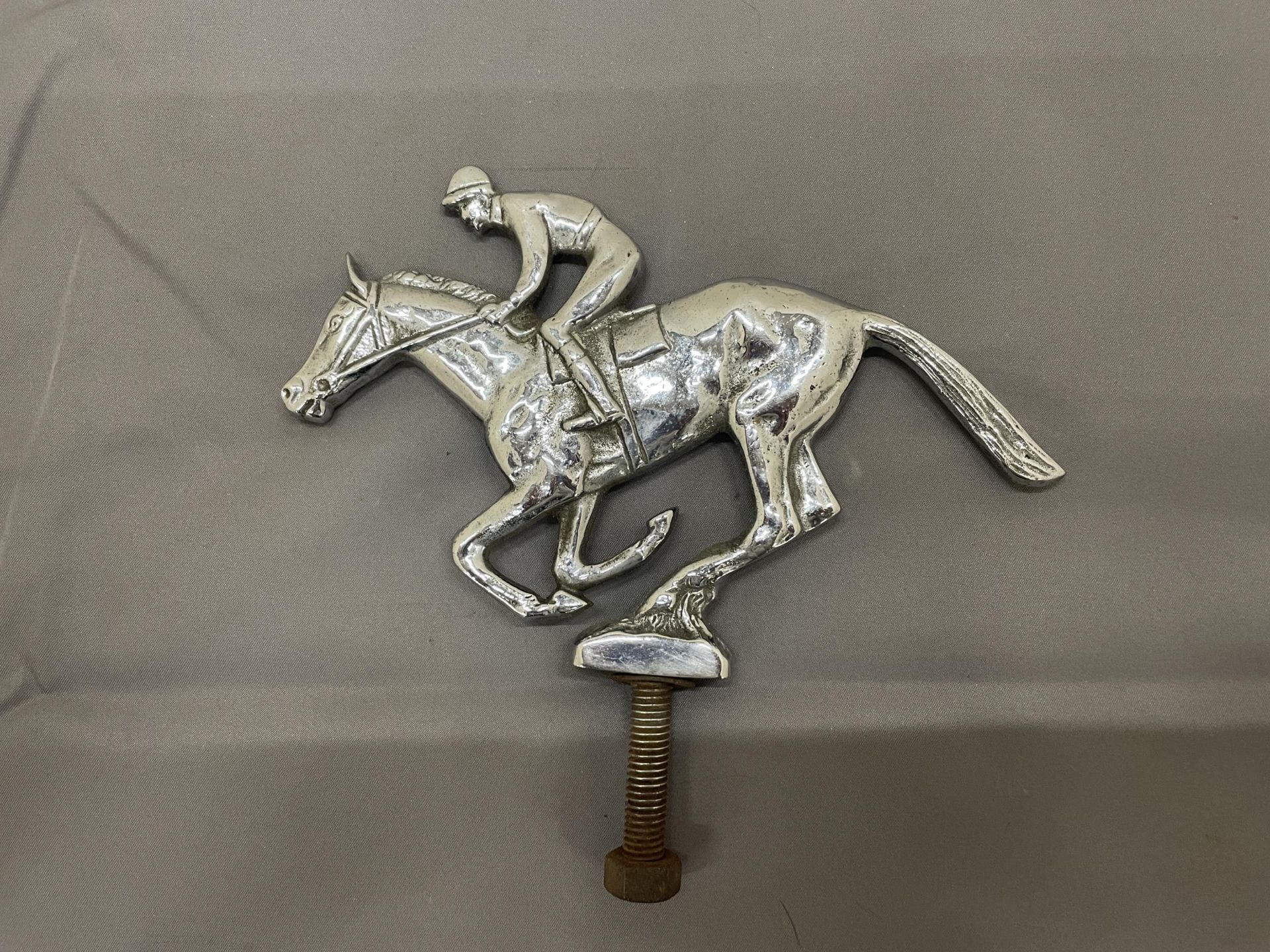 A CHROME VINTAGE HORSE AND JOCKEY CAR MASCOT