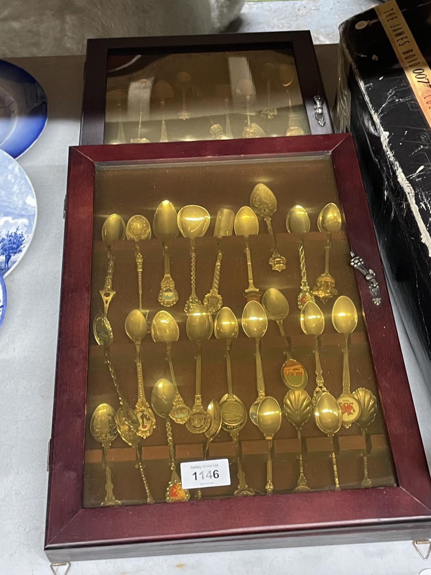 TWO DISPLAY CABINETS CONTAINING SOUVENIR SPOONS