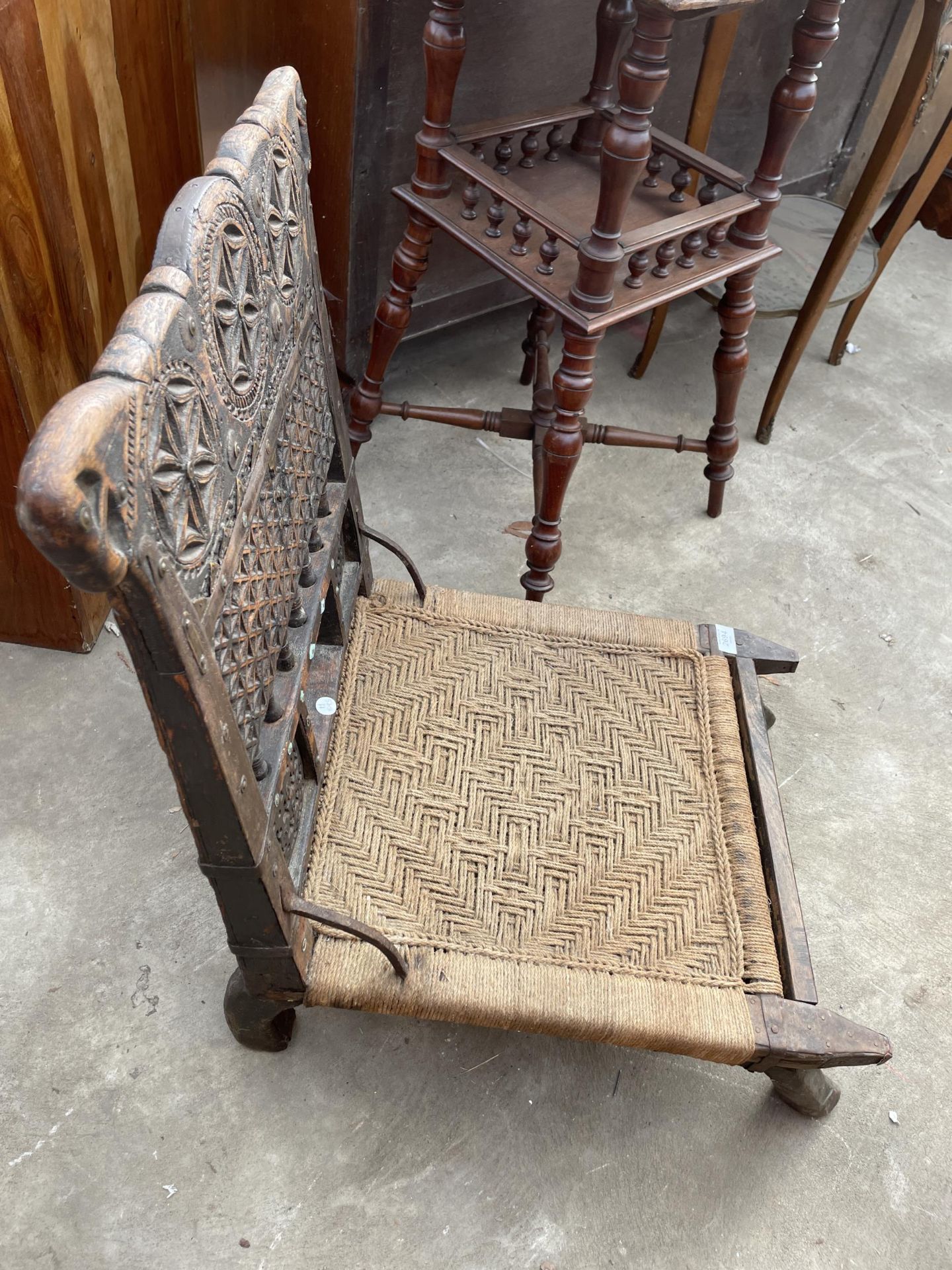 AN INDIAN TRIBAL LOW CHAIR WITH CARVED BACK AND WOVEN SEAT - Image 3 of 6