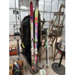 TWO PAIRS OF SKIS AND TWO PAIRS OF SKI POLES WITH A CARRY BAG