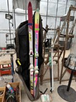 TWO PAIRS OF SKIS AND TWO PAIRS OF SKI POLES WITH A CARRY BAG