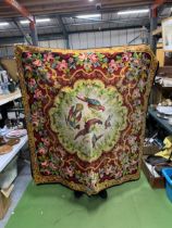 A VINTAGE WOOL WALL HANGING WITH A FLORAL PATTERN