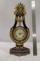 A VICTORIA AND ALBERT MARIE ANTOINETTE STYLE SUN KING GILT METAL MOUNTED PORCELAIN MANTLE CLOCK WITH