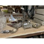 A COLLECTION OF SILVER PLATED ITEMS TO INCLUDE BOTTLE HOLDERS, GOBLETS, A CANDLESTICK, A SHELL DISH,