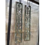 A PAIR OF DECORATIVE BRASS PANELS