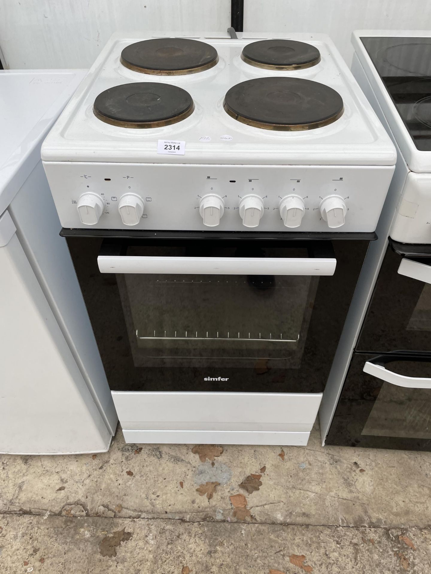 A WHITE AND BLACK SIMFER ELECTRIC OVEN AND HOB