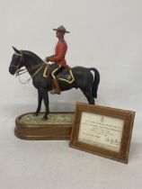 A ROYAL WORCESTER MODEL OF A ROYAL CANADIAN MOUNTED POLICEMAN MODELLED BY DORIS LINDNER AND PRODUCED