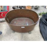 A VINTAGE COPPER TWIN HANDLED PLANTER WITH LION PAW FEET