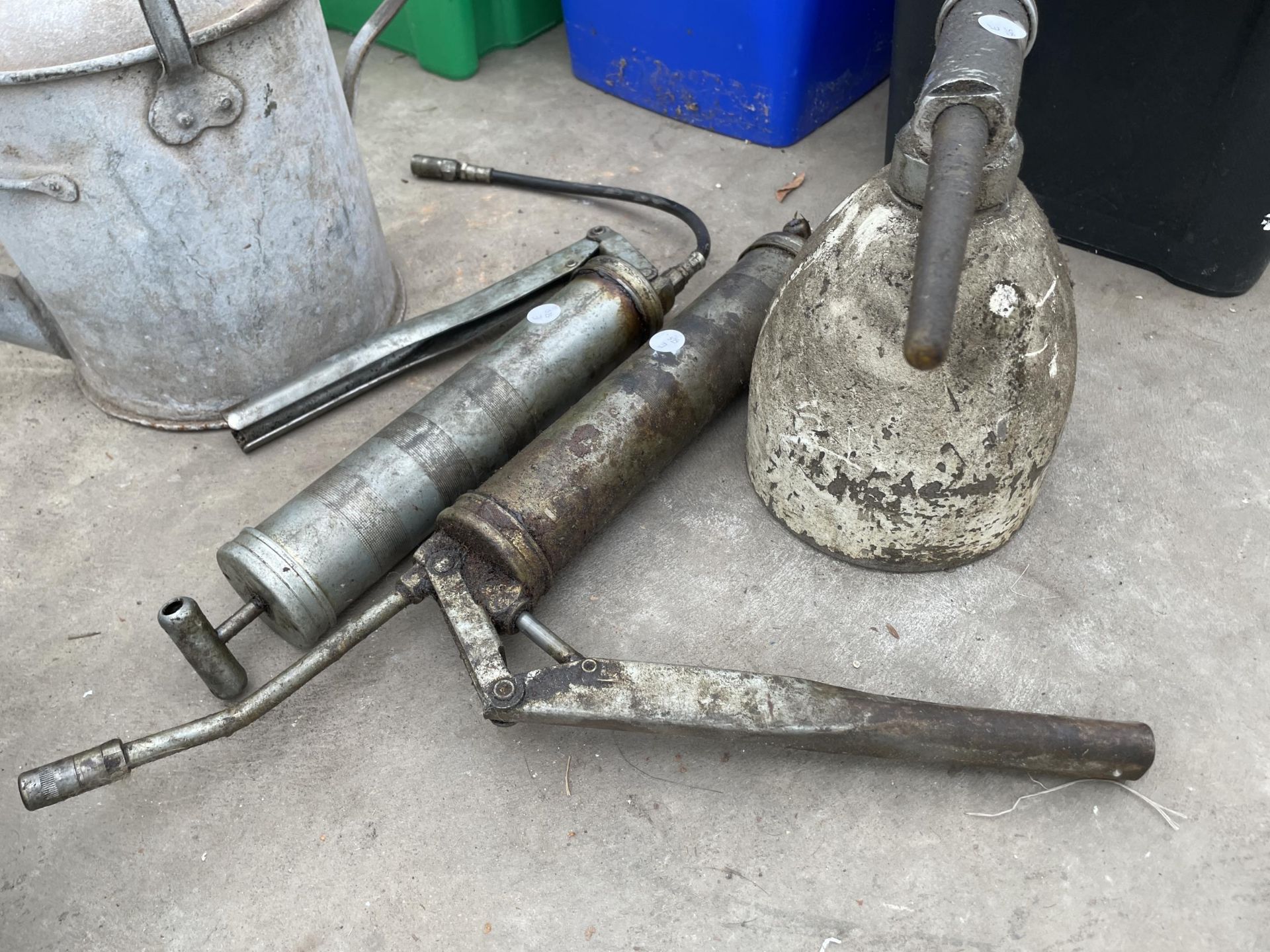 AN ASSORTMENT OF TOOLS TO INCLUDE A GALVANISED WATERING CAN AND TWO GREASE GUNS ETC - Image 2 of 3