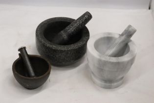 THREE HEAVY PESTLE AND MORTARS TO INCLUDE TWO MARBLE AND A CAST ONE