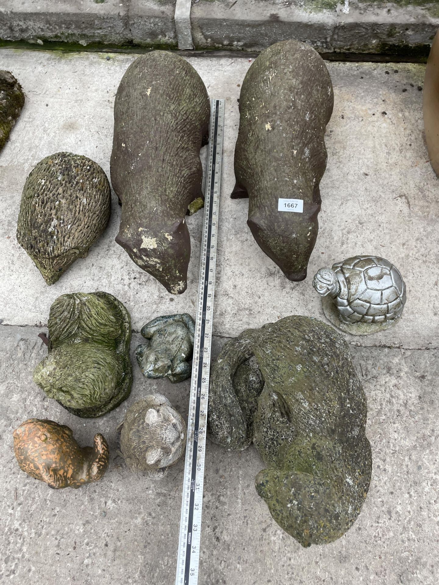 AN ASSORTMENT OF CONCRETE GARDEN FIGURES TO INCLUDE TWO BADGERS AND A HEDGEHOG ETC