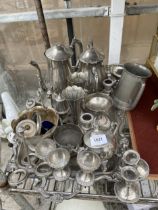 A LARGE ASSORTMENT OF SILVER PLATED ITEMS TO INCLUDE A TRAY, COFFEE POTS, CANDLE STICKS AND EGG CUPS