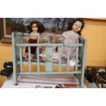 A VINTAGE DOLL'S COT WITH THREE DOLLS, ONE A PALITOY AND A TEDDY BEAR