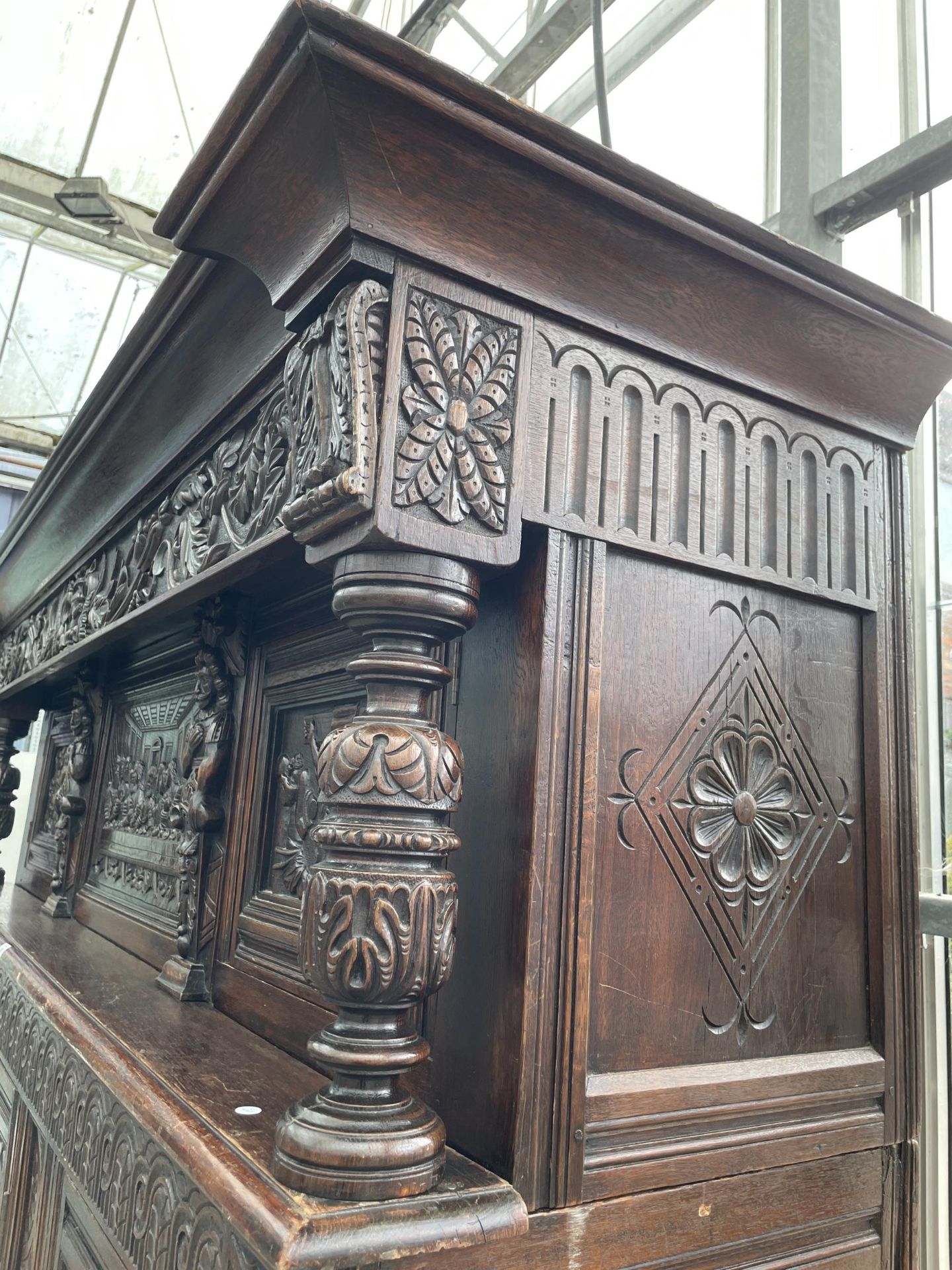 AN OAK GEORGE III STYLE COURT CUPBOARD WITH CARVED PANELS, THREE DEPICTING THE BIRTH AND CRUCIFIXION - Image 12 of 12
