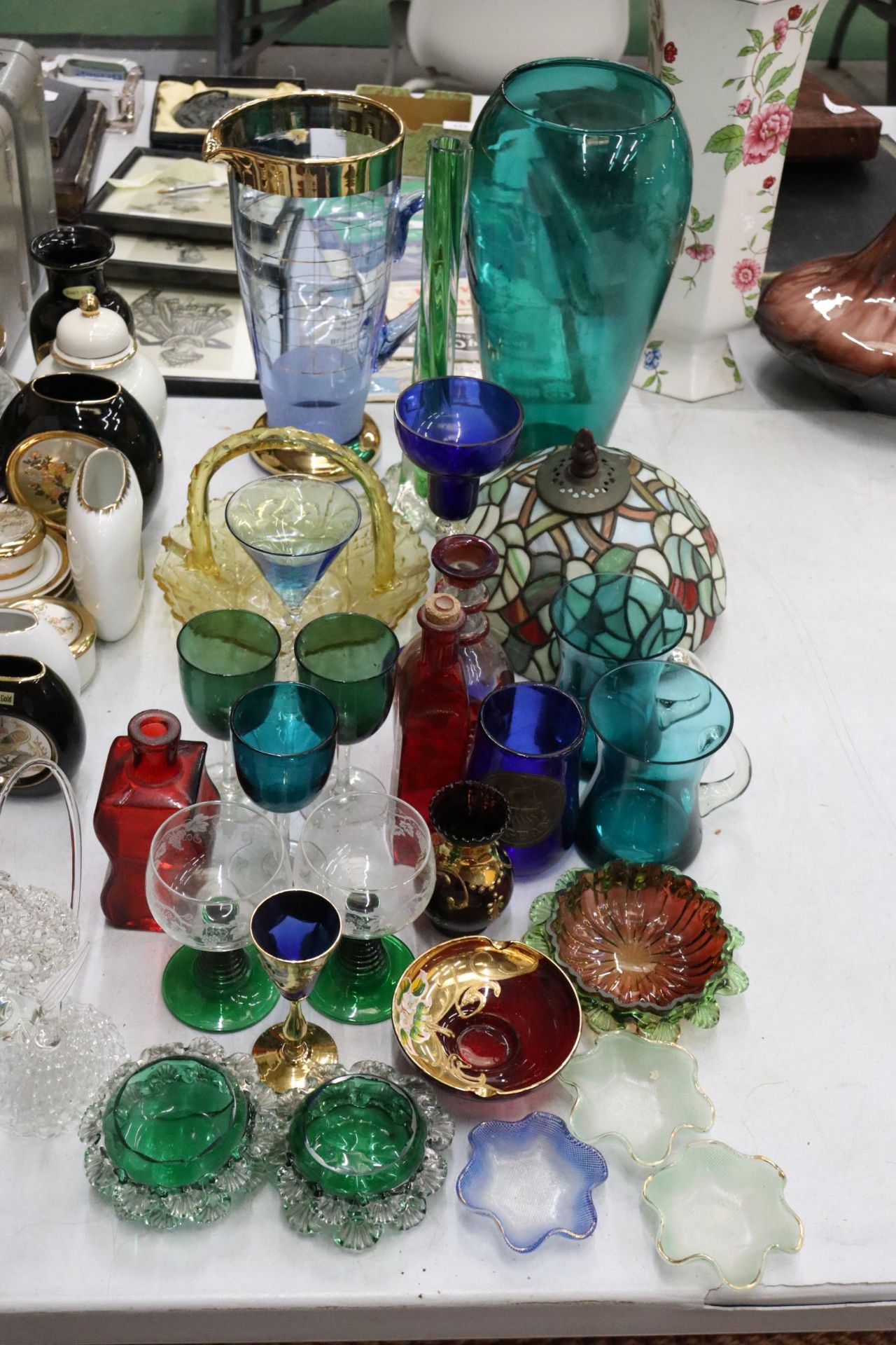 A LARGE QUANTITY OF COLOURED GLASS TO INCLUDE VASES, WINE GLASSES, CANDLE HOLDERS, ETC.,