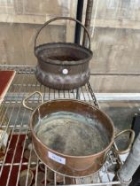 A COPPER COULDRON AND A COPPER PAN WITH TWIN BRASS HANDLES