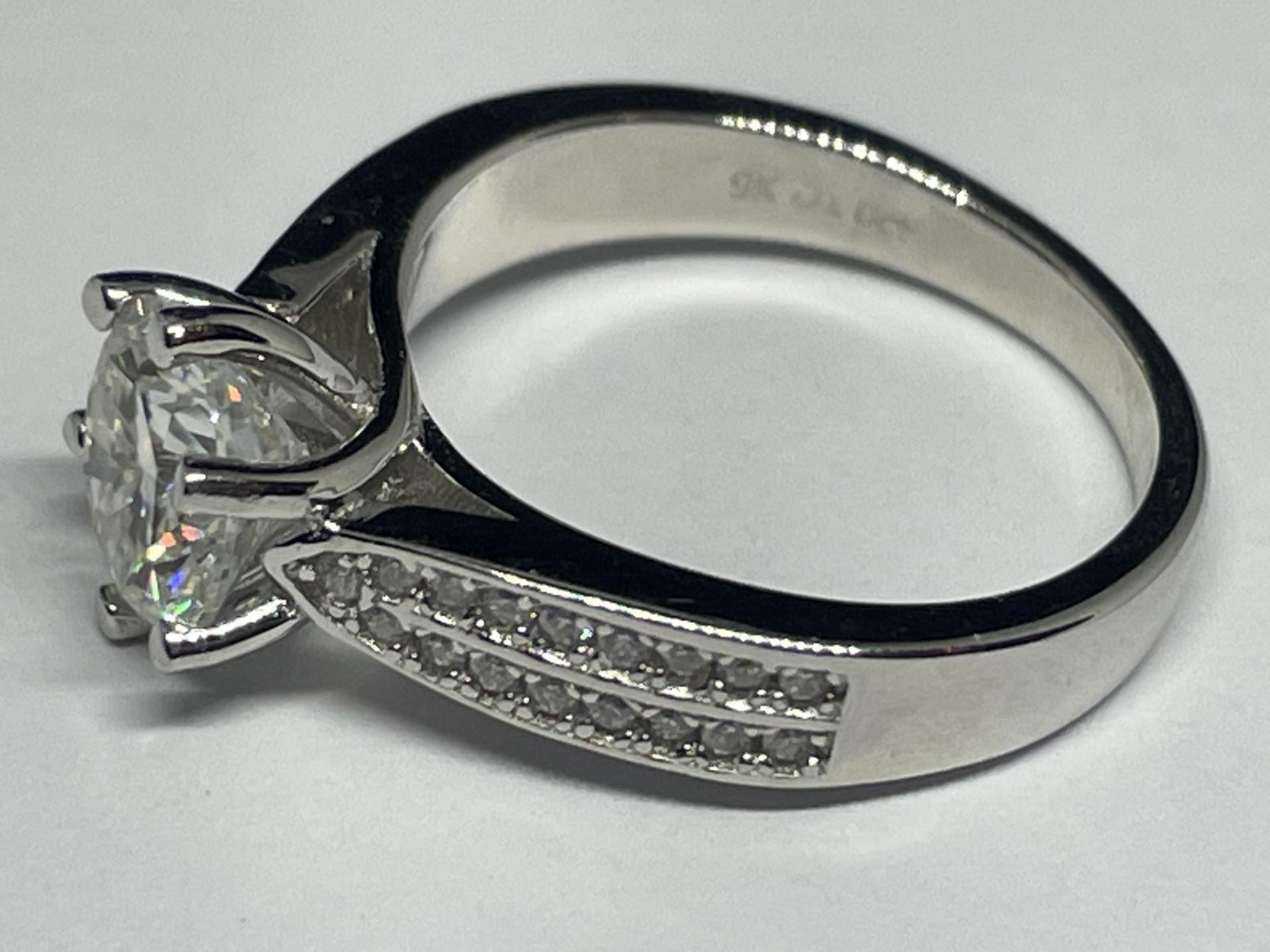 A MARKED 9K RING SET WITH A 1 CARAT OF MOISSANITE AS A SOLITAIRE AND CHIPS TO SHOULDERS SIZE H/I - Image 2 of 3