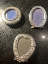 THREE MINIATURE HALLMARKED SILVER PHOTOGRAPH FRAMES TO INCLUDE A DECORATIVE HEART SHAPED EXAMPLE
