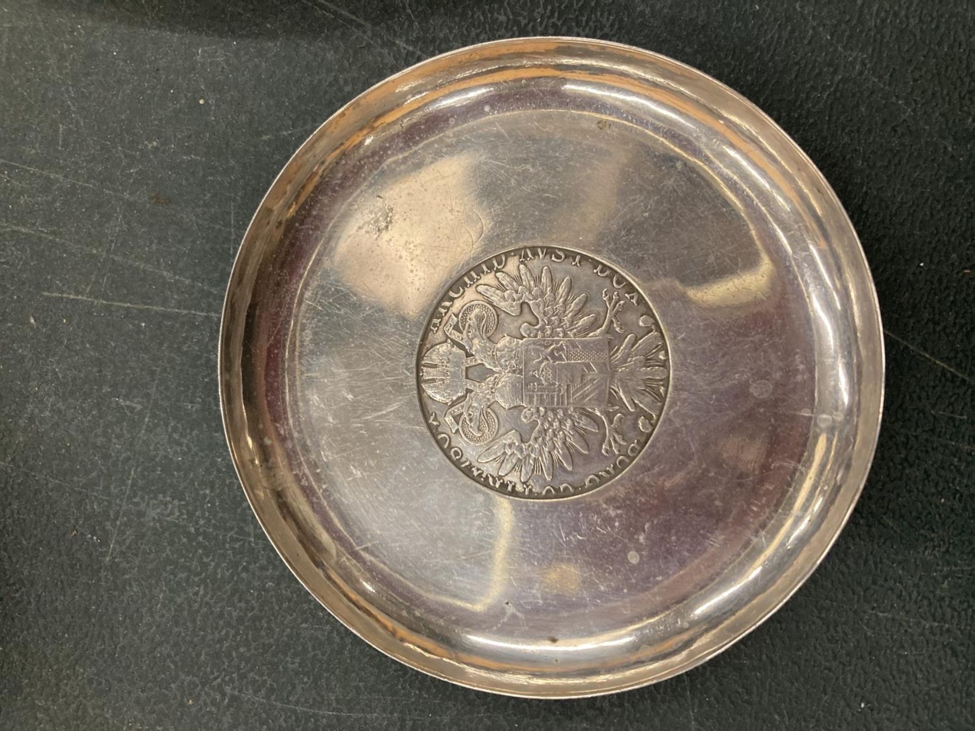 A DISH WITH A COIN STYLE INSERT