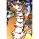 A ROYAL ALBERT 'COUNTRY ROSES PART TEASET TO INCLUDE A TEAPOT, CUPS, SAUCERS AND SIDE PLATES