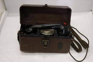 A WORLD WAR 11 MILITARY TELEPHONE IN A LEATHER CASE