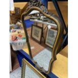 A GILT FRAMED MIRROR AND A SCALLOPED SHAPED MIRROR