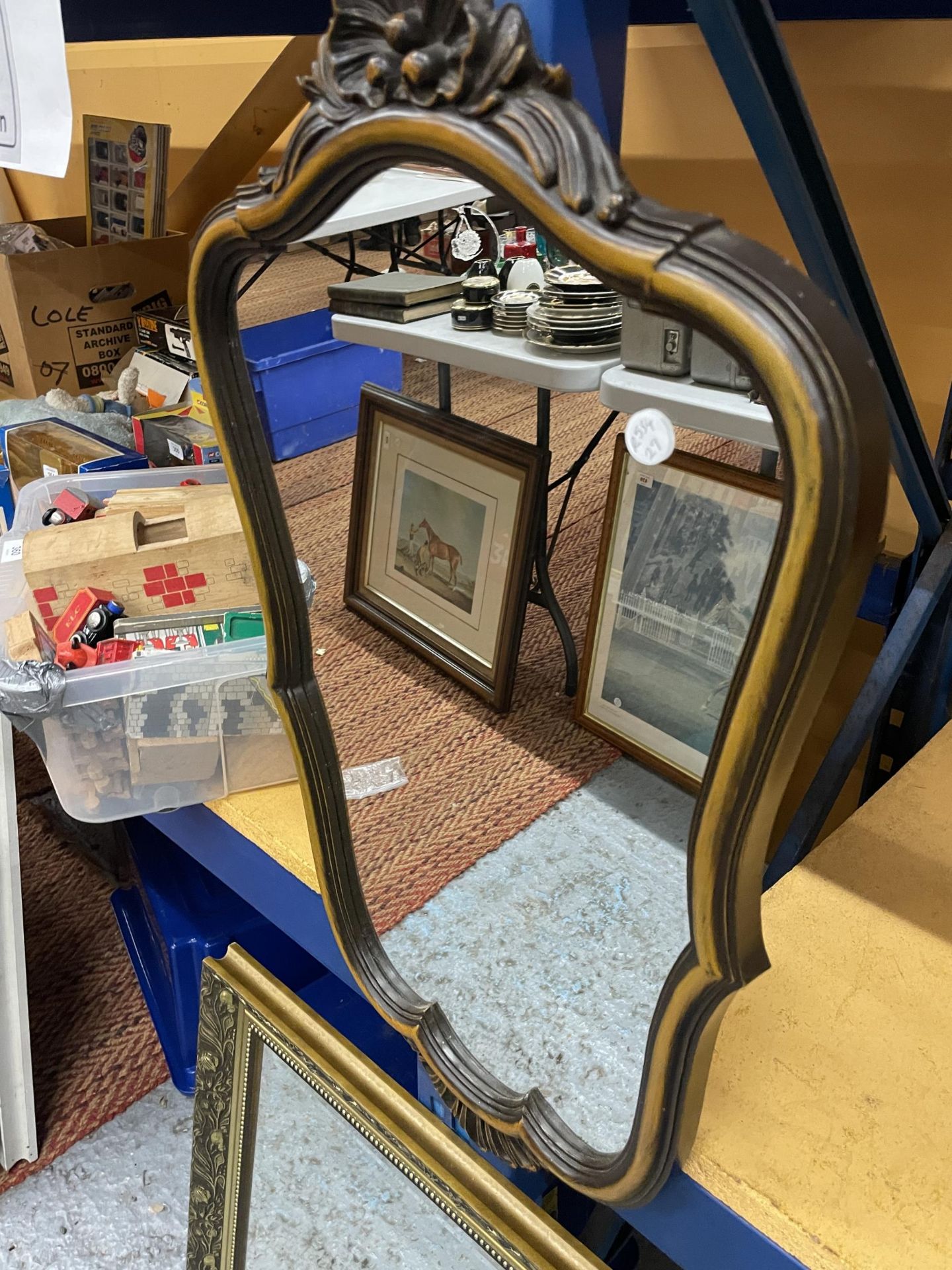 A GILT FRAMED MIRROR AND A SCALLOPED SHAPED MIRROR