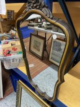 A GILT FRAMED MIRROR AND A SCALLOPED SHAPED MIRROR