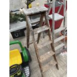 A VINTAGE FOUR RUNG WOODEN STEP LADDER