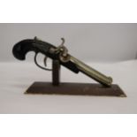 A HEAVY, VINTAGE, PISTOL LIGHTER ON A WOODEN STAND, LENGTH 21CM