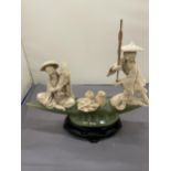 AN ORIENTAL CARVING OF FISHERMEN ON A POSSIBLY JADE BOAT, HEIGHT 20CM, WIDTH 27CM