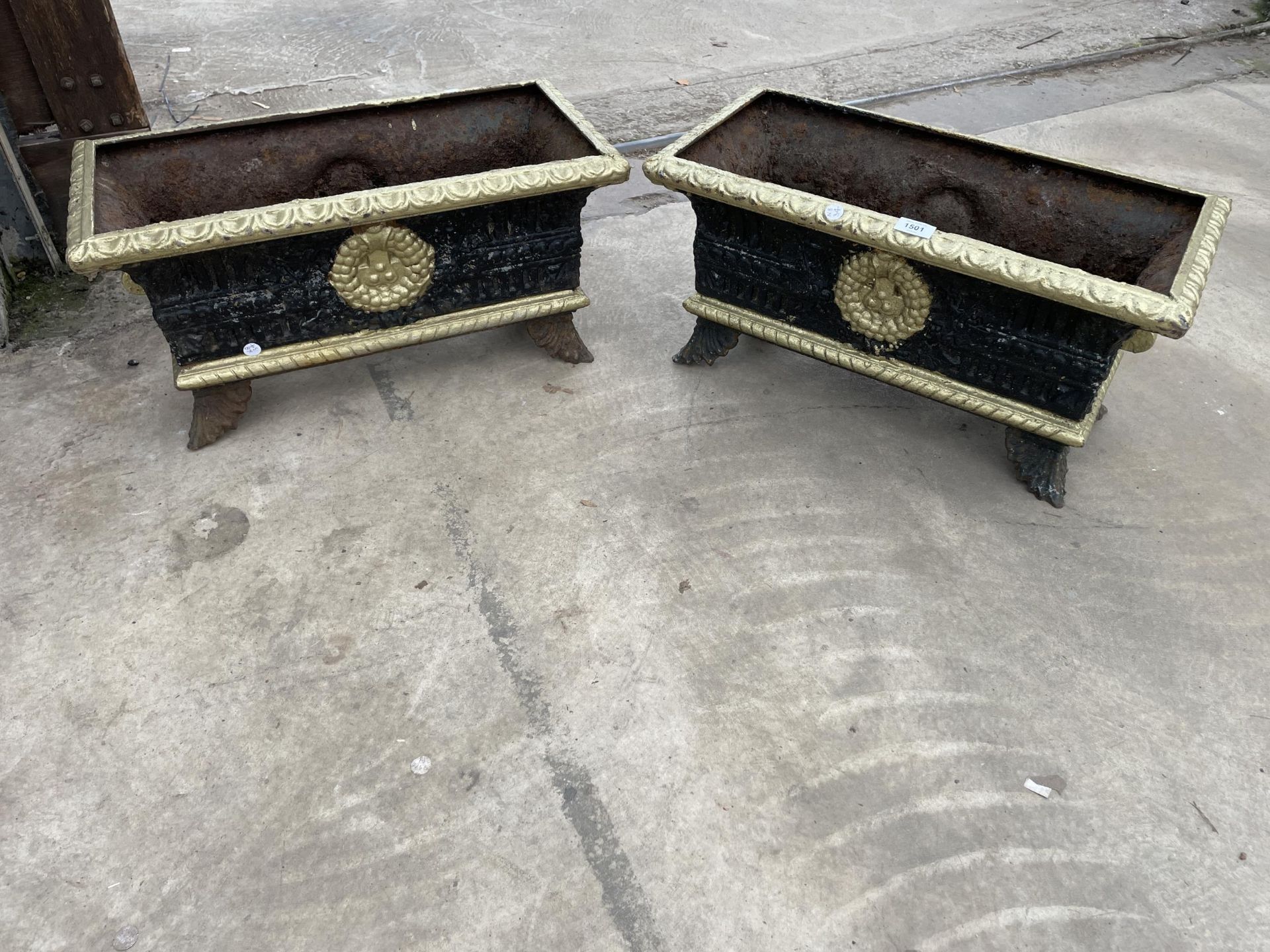 A PAIR OF VINTAGE DECORATIVE BLACK AND GOLD PAINTED CAST IRON TROUGH PLANTERS
