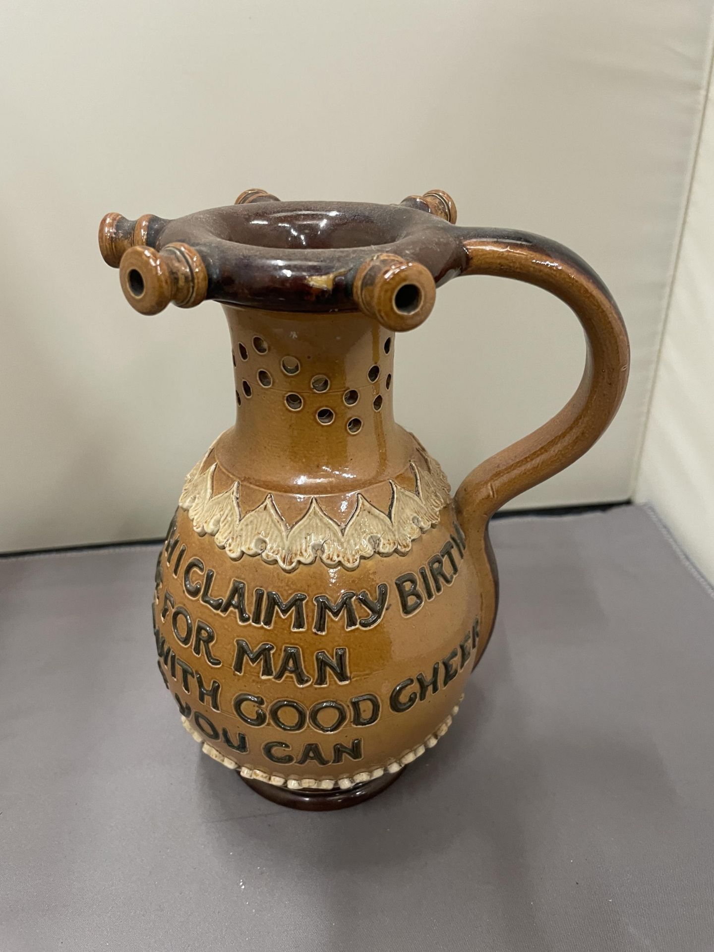 A ROYAL DOULTON LAMBETH PUZZLE JUG WITH A FOUR LINE VERSE