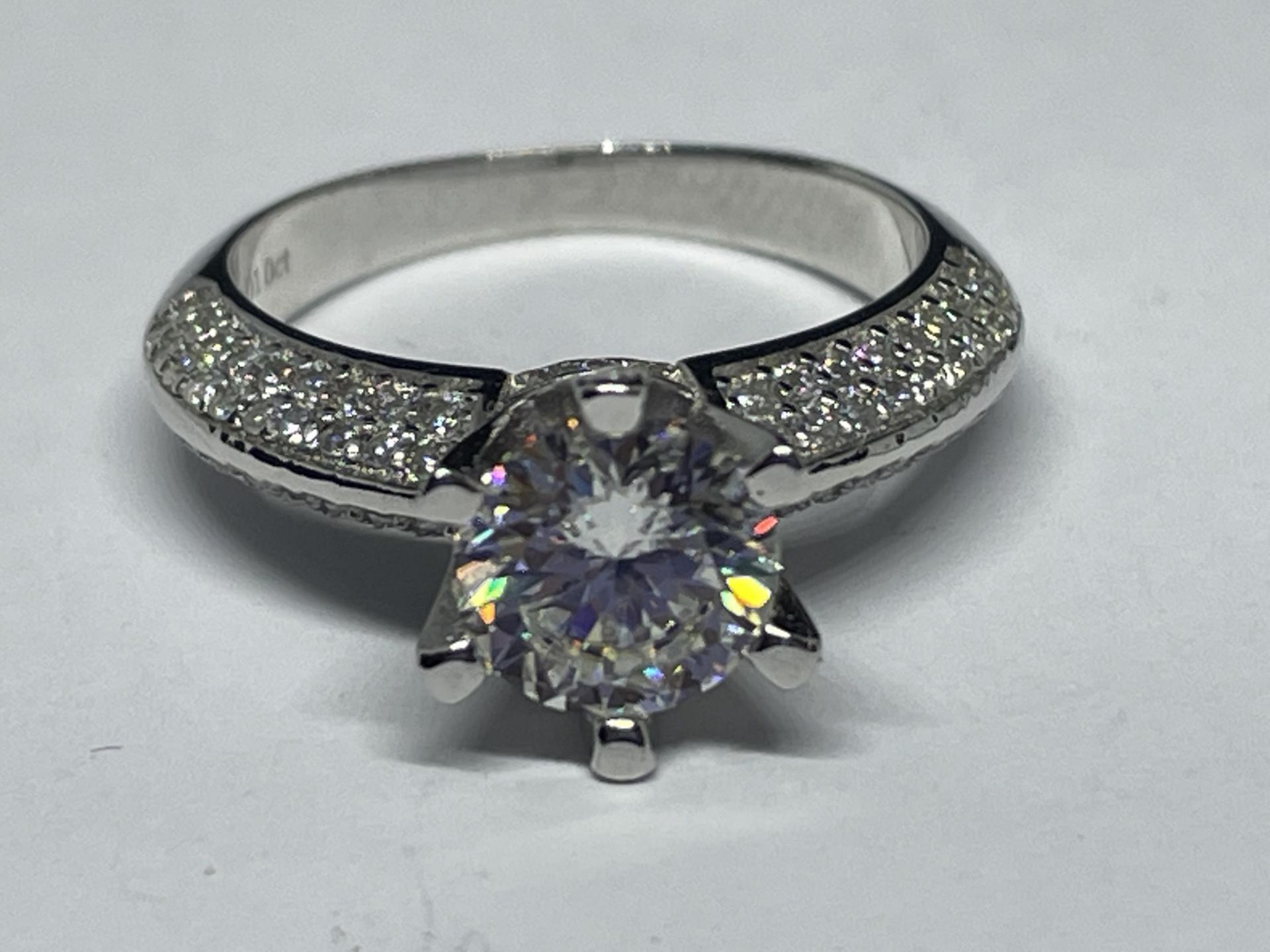 A MARKED 9K RING SET WITH A 1 CARAT MOISSANITE AND SMALLER ONES TO THE SHOULDERS