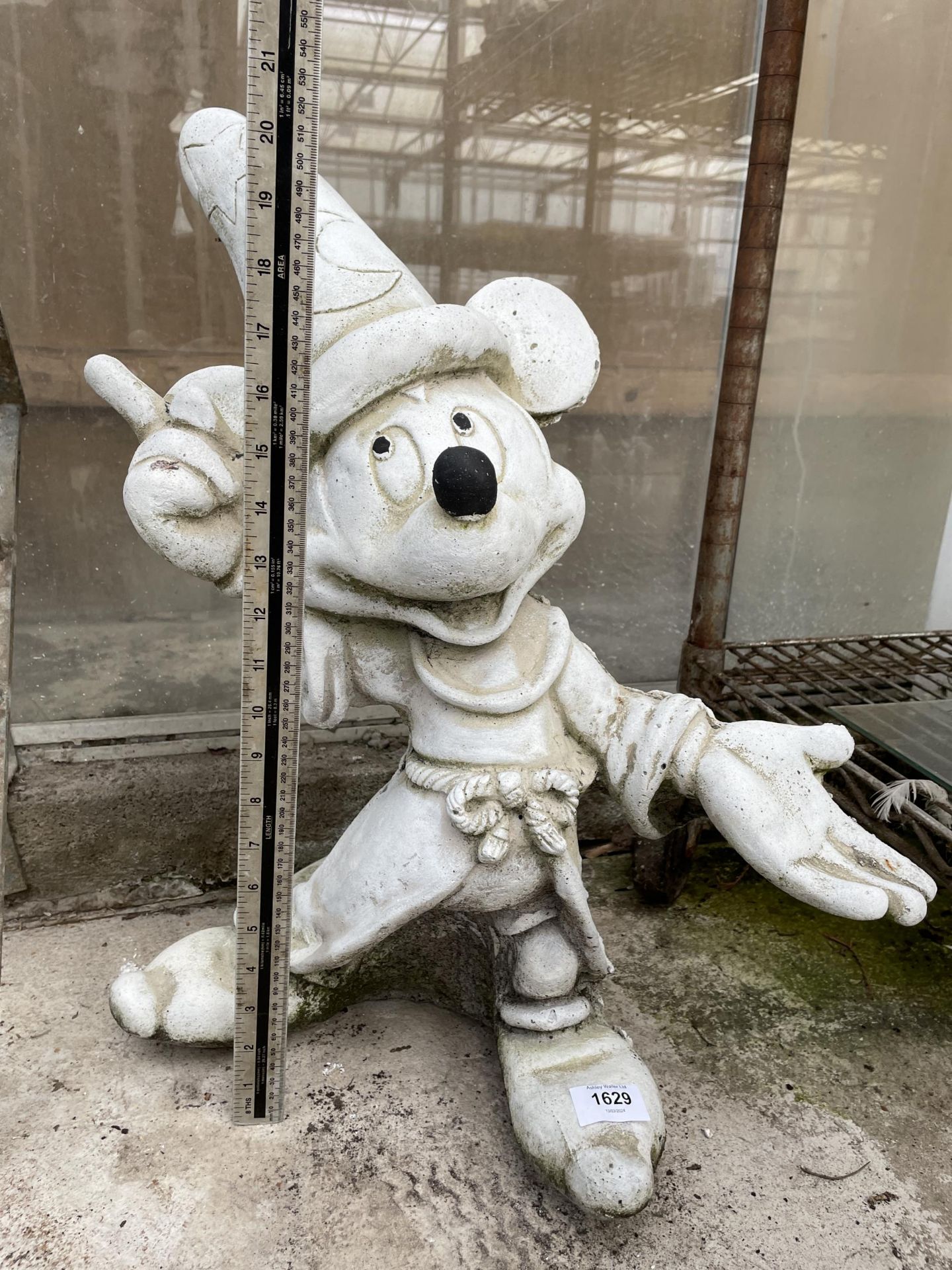 A RECONSTITUTED STONE MICKEY MOUSE FIGURE