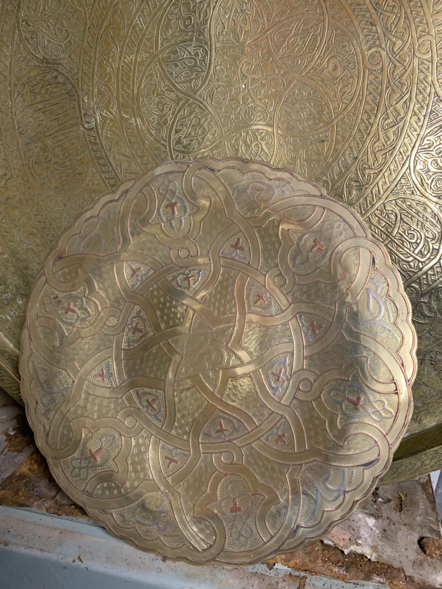 A LARGE HEAVY ISLAMIC BRASS CHARGER, DIAMETER 56CM PLUS A SMALLER PLATE WITH INLAID SILVER AND - Image 2 of 3