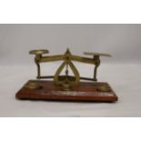 AN ANTIQUE POSTAL SCALE BRASS AND WOOD BASE