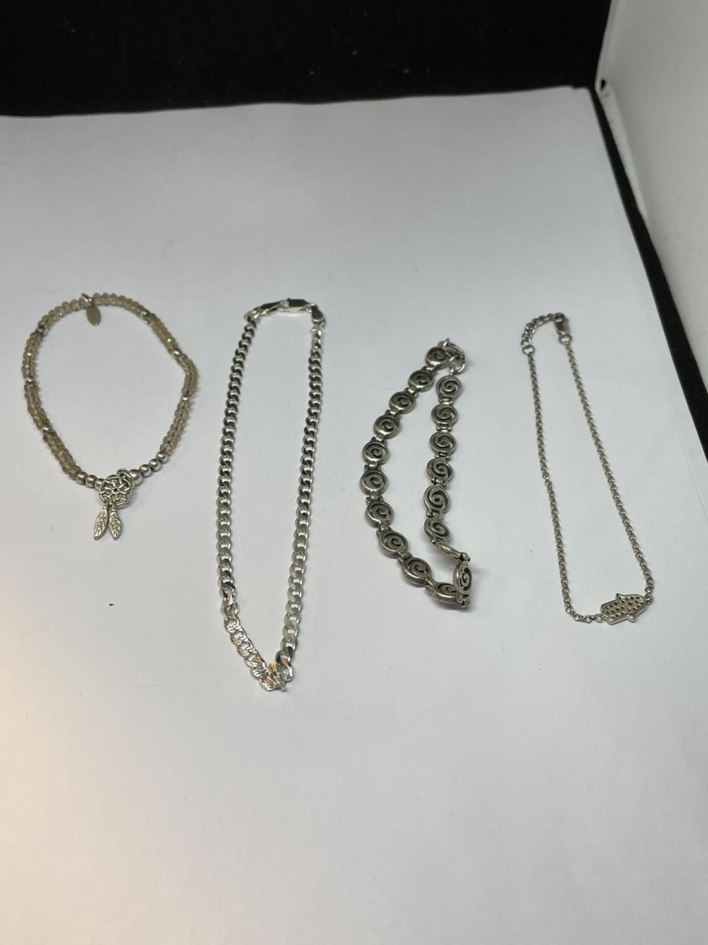 FOUR SILVER BRACELETS