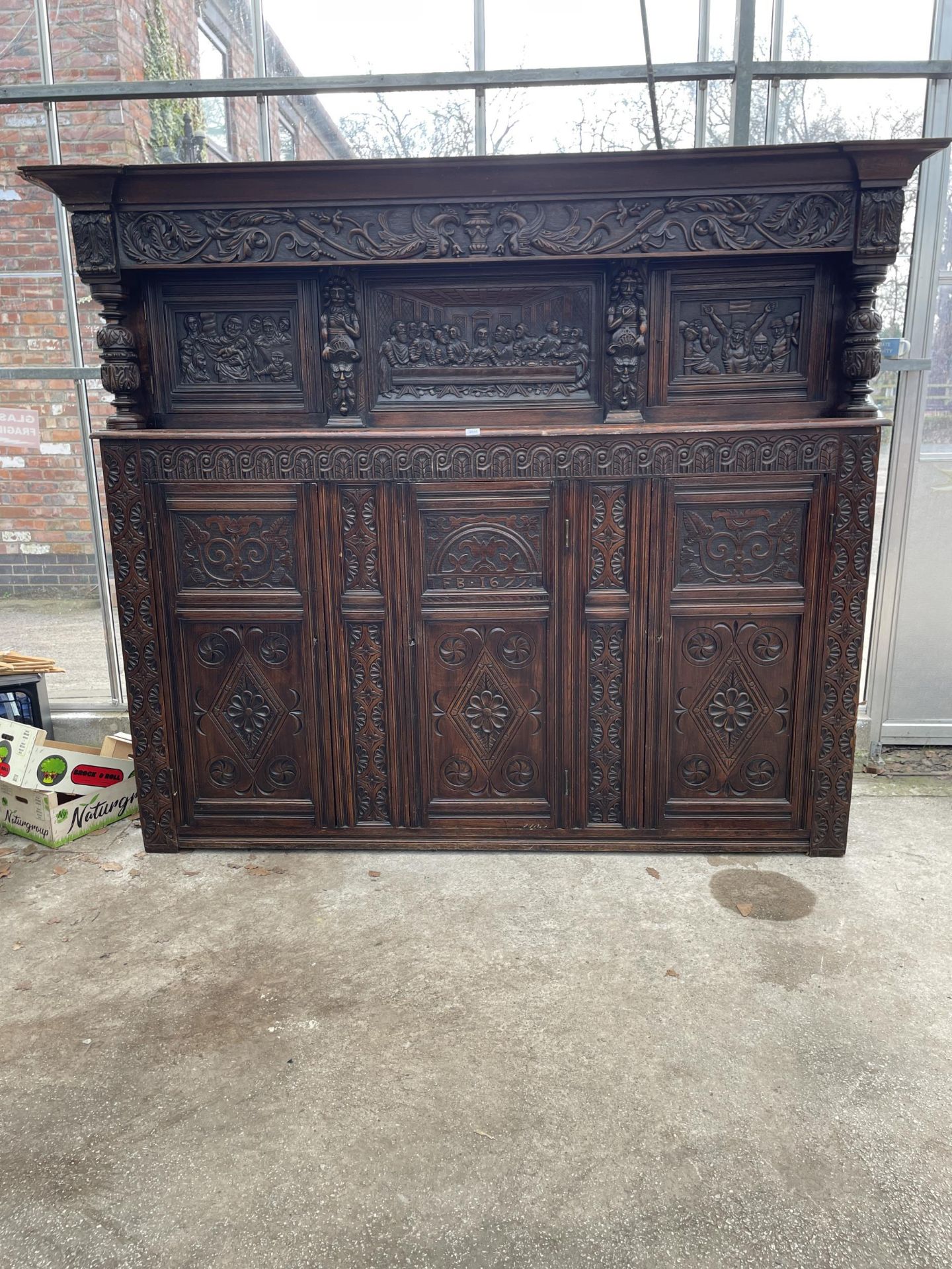 AN OAK GEORGE III STYLE COURT CUPBOARD WITH CARVED PANELS, THREE DEPICTING THE BIRTH AND CRUCIFIXION